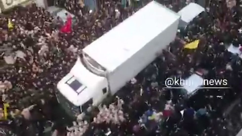 State television shows emotional mourners in Iranian city of Mashhad swarming around a truck carrying the bodies of Qassem Suleimani and Abu Mahdi al-Mohandes