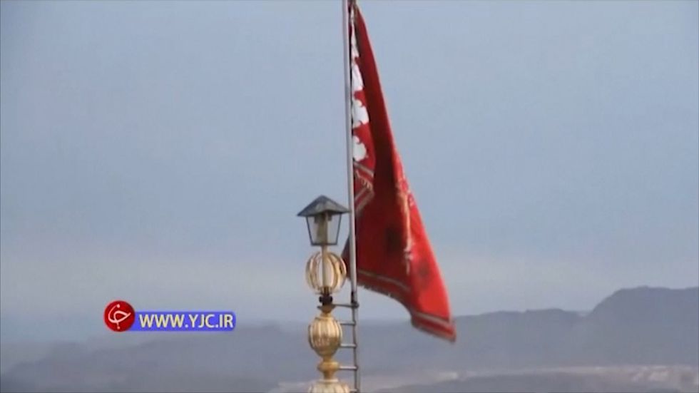 Red flag signaling war raised atop the Jamkaran mosque in Iran