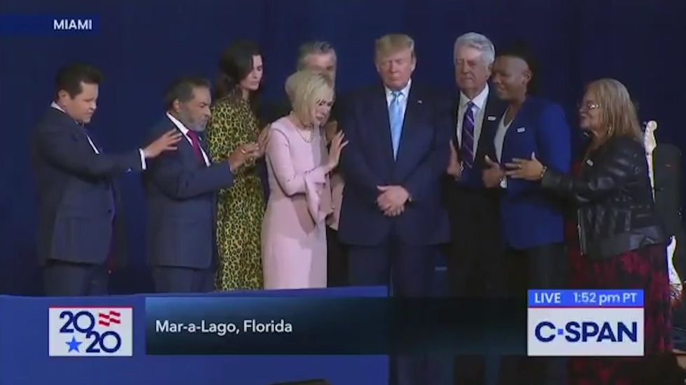 Donald Trump takes part in a prayer during 'Evangelicals for Trump' event in Florida