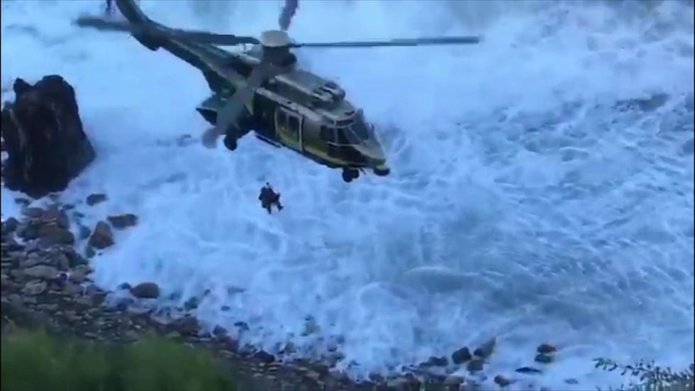Woman rescued after falling off 100ft cliff while looking at her phone