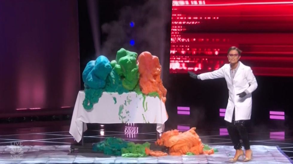 Biochemist Camille Schrier performs science experiment on stage before being crowned the new Miss America