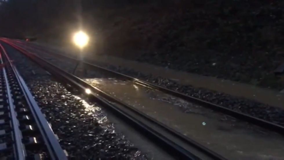 UK weather: Flooded railway tracks lead to major travel disruption in south east England