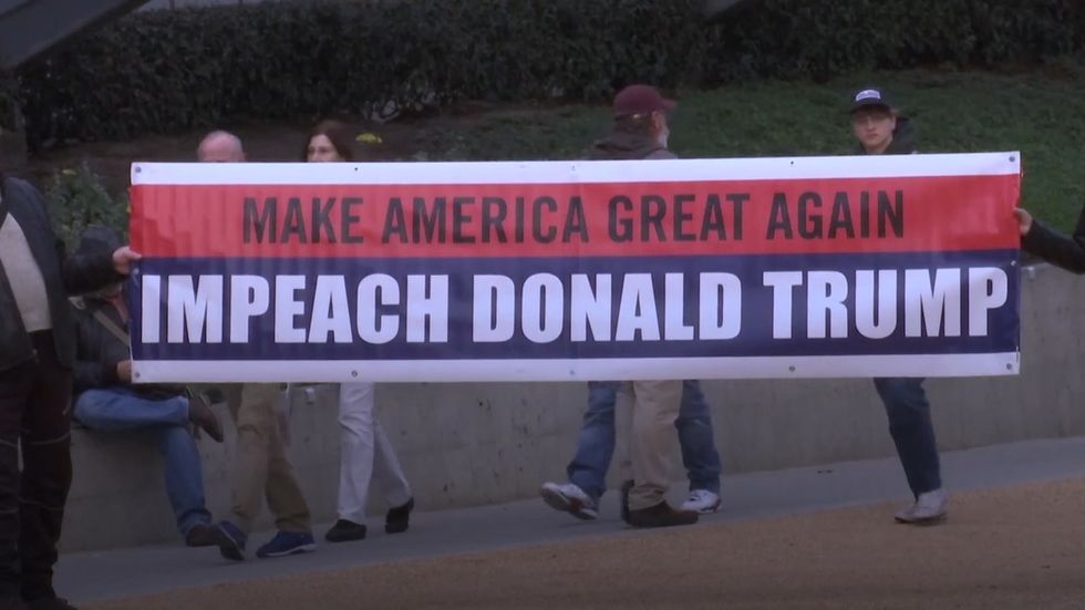 Demonstrators march in support of impeaching Donald Trump