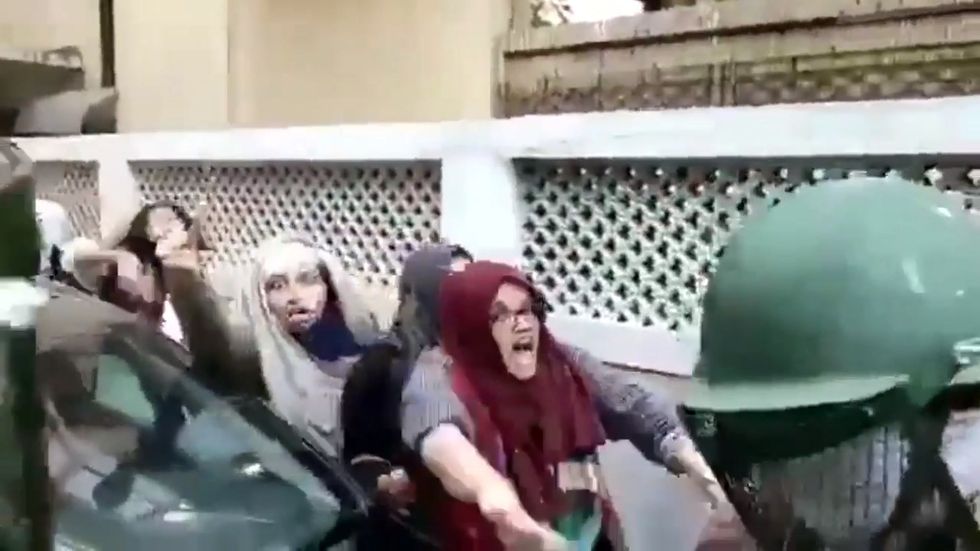 Girls in hijabs stand up to Indian riot police in Delhi