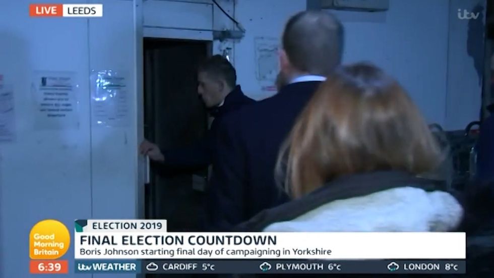 Boris Johnson's minder swears at reporter live on tv as PM's team whisk him off into a giant fridge