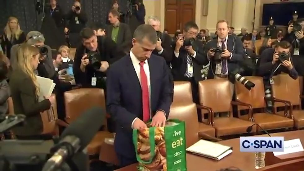 Republican lawyer Steve Castor arrives at impeachment hearings with a shopping bag