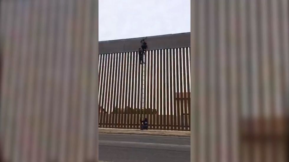 People scale US border wall in seconds - despite Trump insisting it 'can't be climbed'