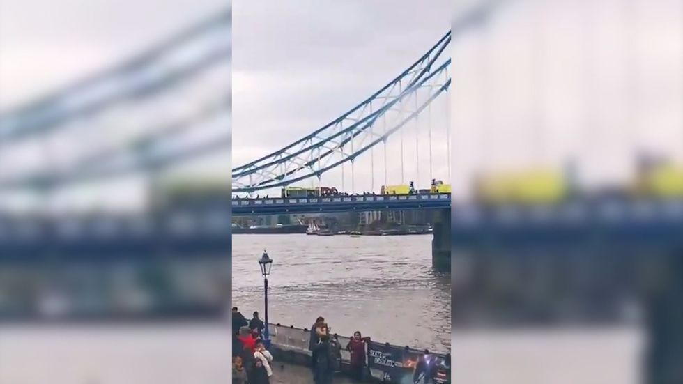 Emergency services seen on Tower Bridge as fire brigade try to rescue injured person