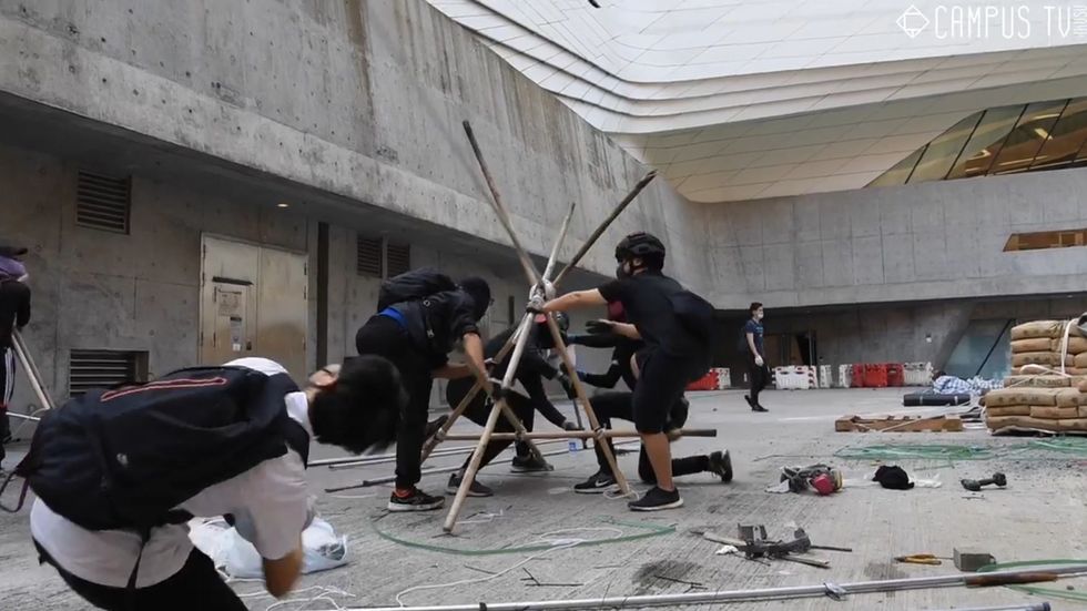 Hong Kong students use giant makeshift catapult to defend themselves and attack police