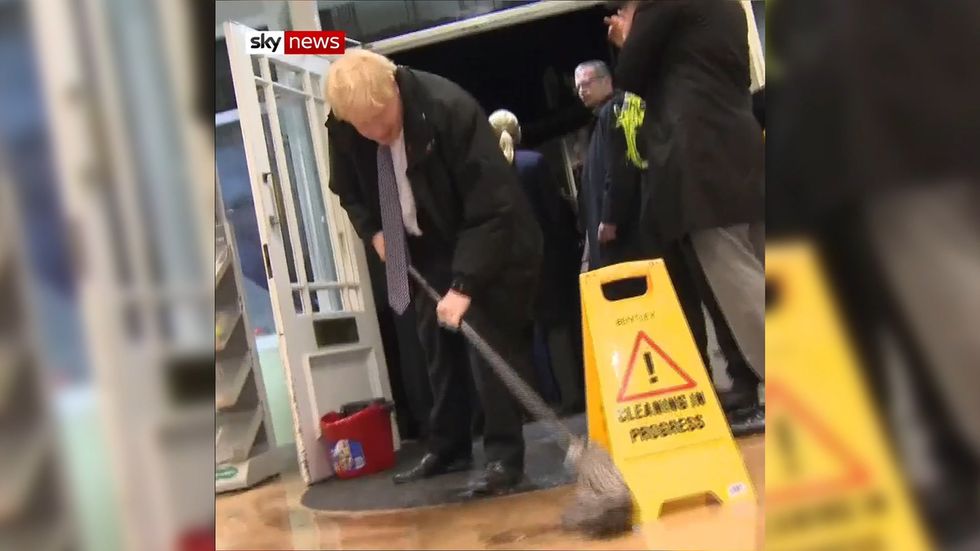 Boris Johnson pitches in with flooding clean-up