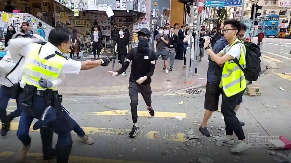 Hong Kong police shoot man in day of violence 
