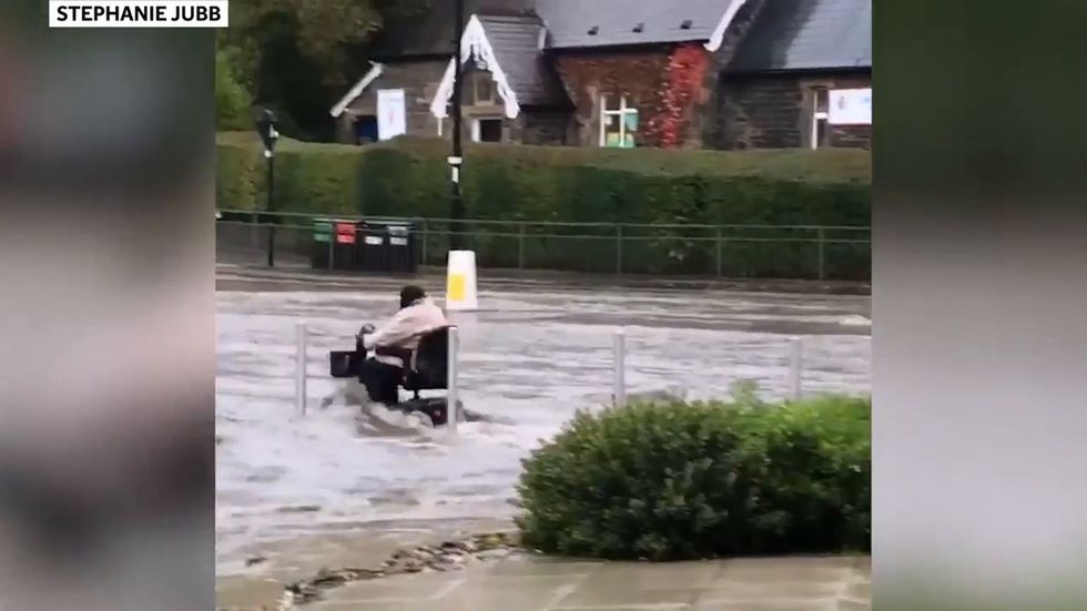 Woman drives mobility scooter through floodwater in Sheffield