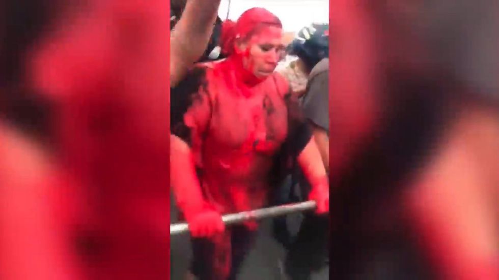 Patricia Arce, mayor of Bolivian town Vinto, marched through street after being covered in red paint