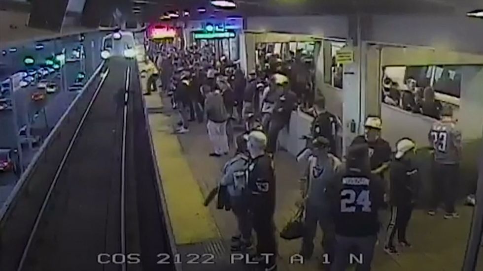 Railway worker pulls passenger to safety after he falls on train tracks in California 