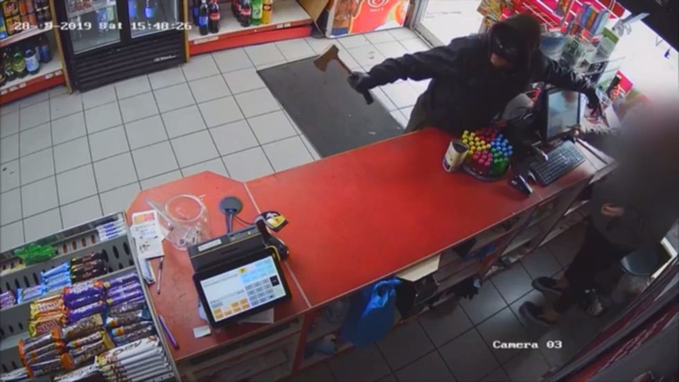 Police release CCTV footage in appeal for armed axe robber in Manchester