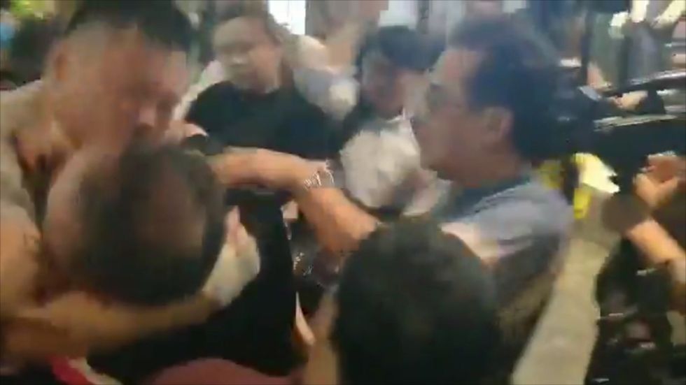 Pro-democracy councillor's ear part-bitten off in Hong Kong brawl