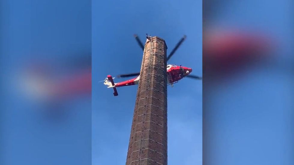 Emergency services attempt to rescue man stuck at top of 290-ft Dixon's chimney in Carlisle