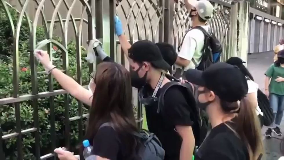 Hong Kong protesters clean mosque after police spray it with blue liquid