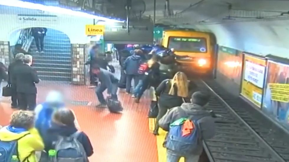 Woman falls onto subway tracks as train approaches after man faints on her