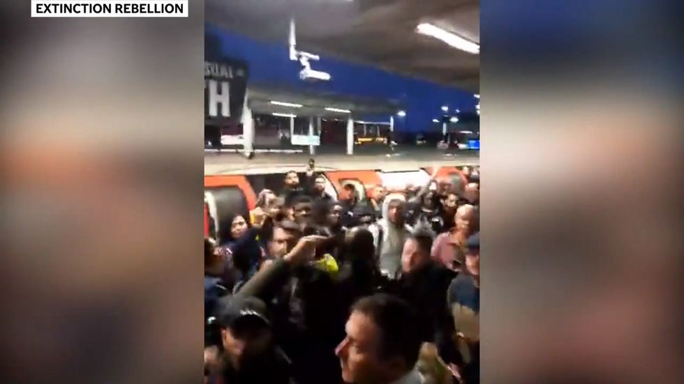 Angry commuters in London attack Extinction Rebellion protester claiming to be journalist