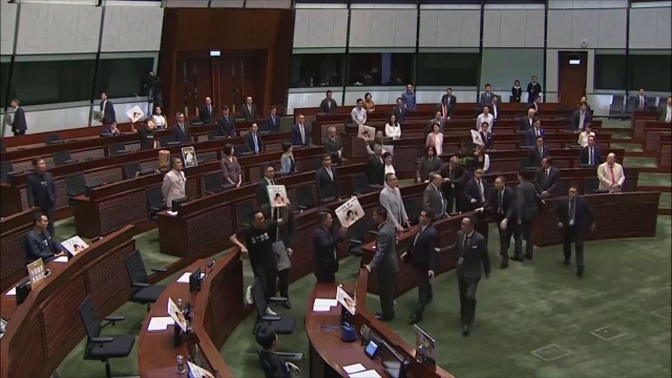 Protesters disrupt Hong Kong parliament during Carrie Lam speech
