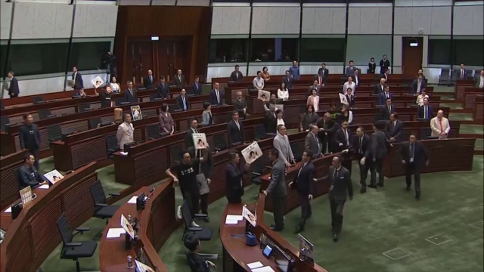 Protesters disrupt Hong Kong parliament during Carrie Lam speech