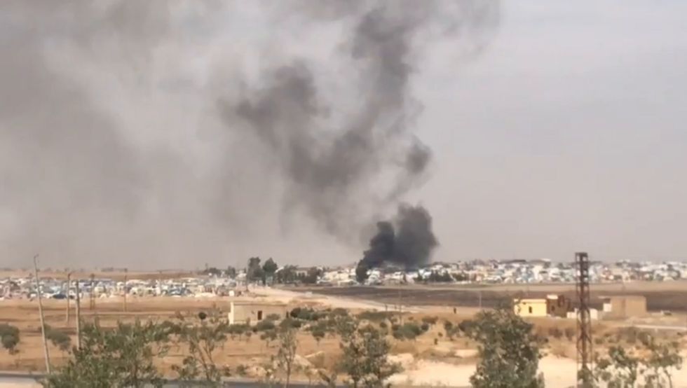 Smoke rises from Ain Issa camp in Syria as clashes continue