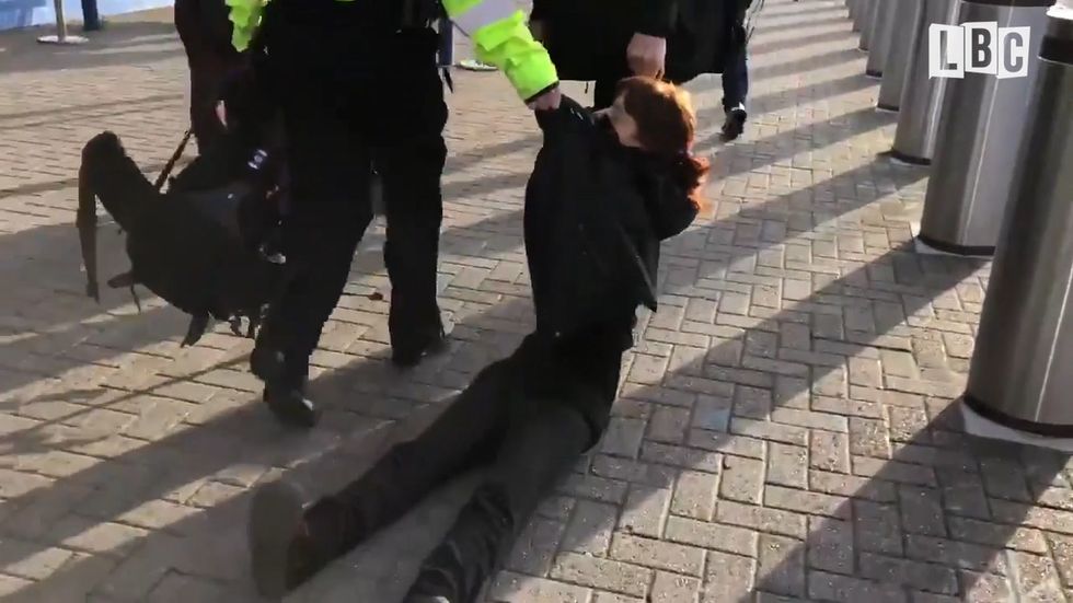 Two women from Extinction Rebellion are dragged out of London City airport by police