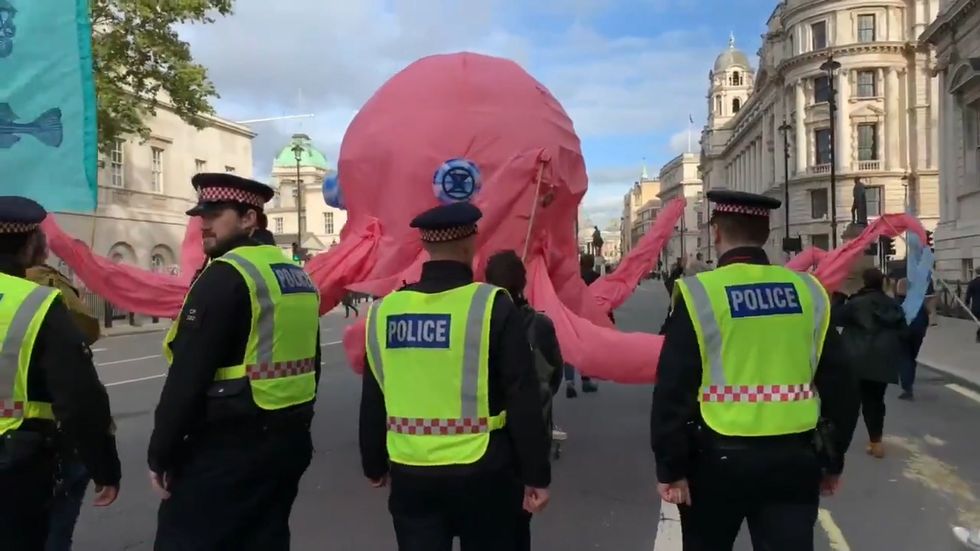 Police kettle giant pink Octopus in bizarre Extinction Rebellion protest scenes