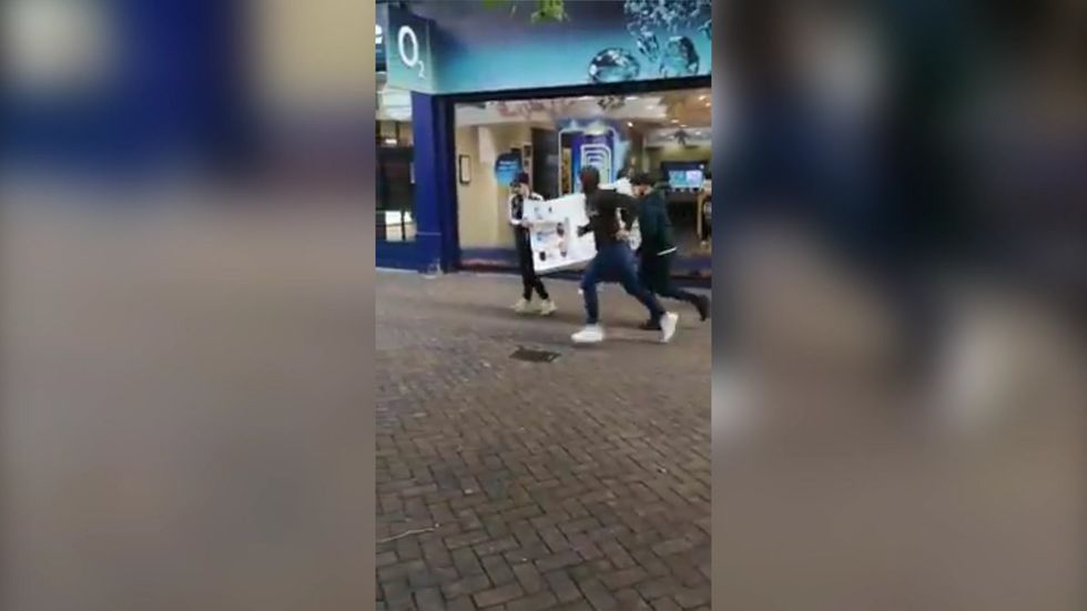 Men run off with display shelf of mobile phones from shop in brazen robbery