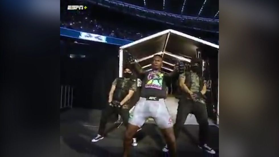 Israel Adesanya dances during his walkout at UFC 243