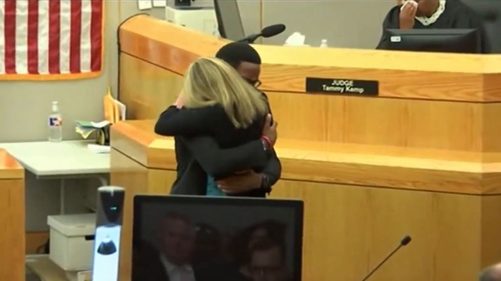 Brother of murdered black man Botham Jean hugs killer Amber Guyer as he forgives her in court
