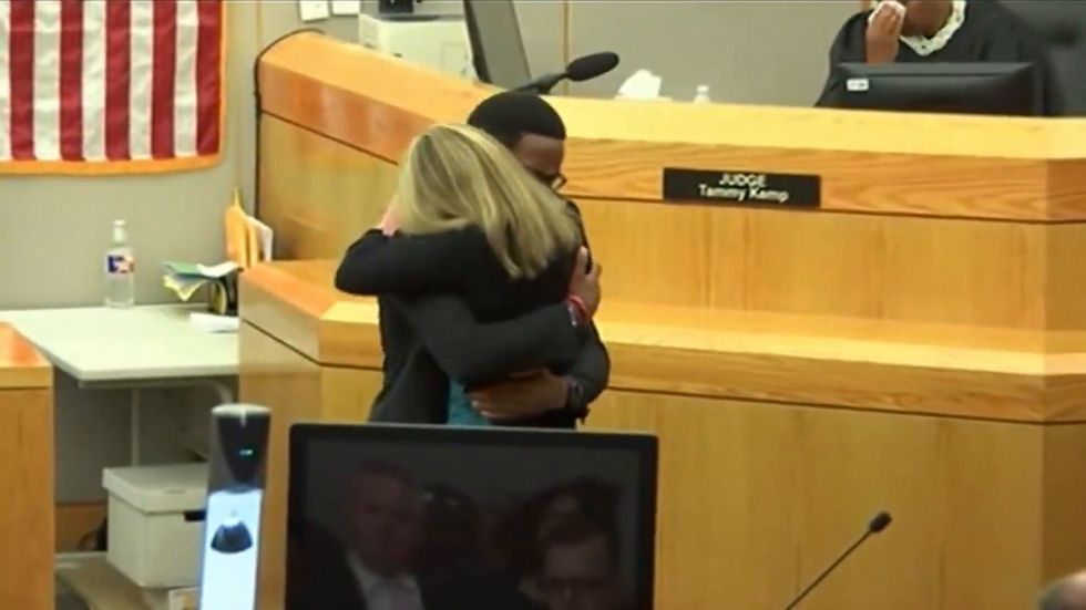 Brother of murdered black man Botham Jean hugs killer Amber Guyer as he forgives her in court