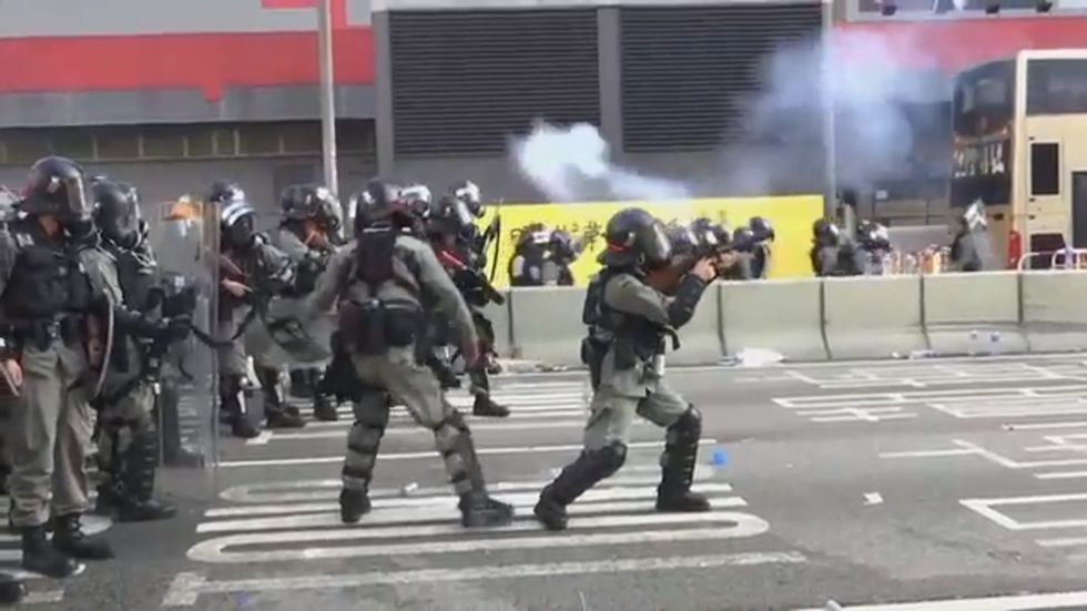 Hong Kong police fire tear gas and a water cannon at protesters on China's 70th anniversary