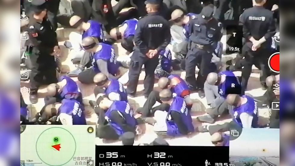 Drone footage purports to show prisoners in China shackled and blindfolded