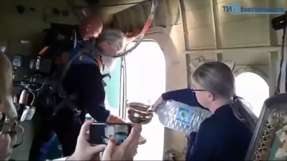 Russian priests spray holy water from plane to stop 'alcohol use and fornication'