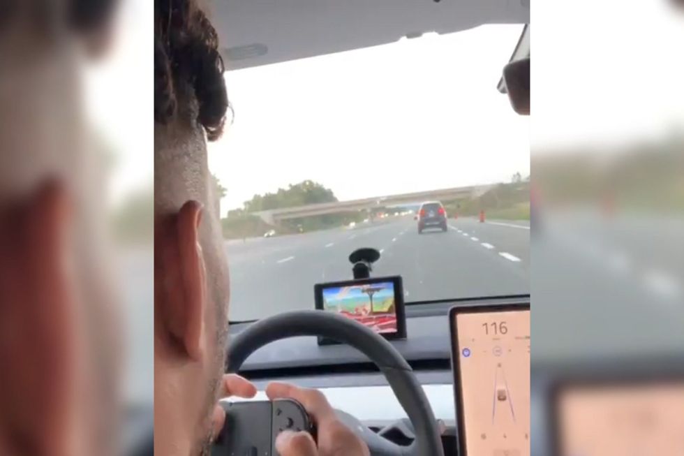Kevin Lee films himself playing computer game at the wheel of driverless car