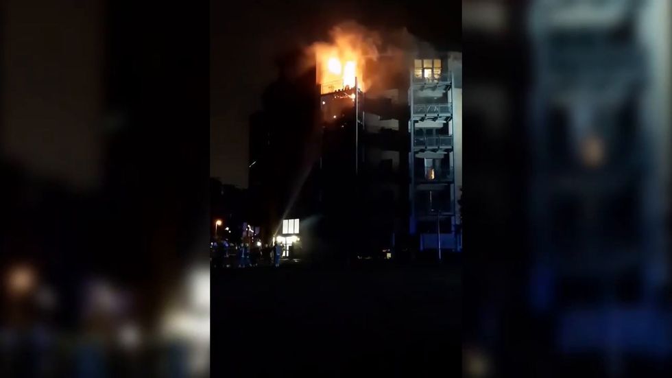 Fire brigade tackle blaze at block of flats in Hackney, North London 