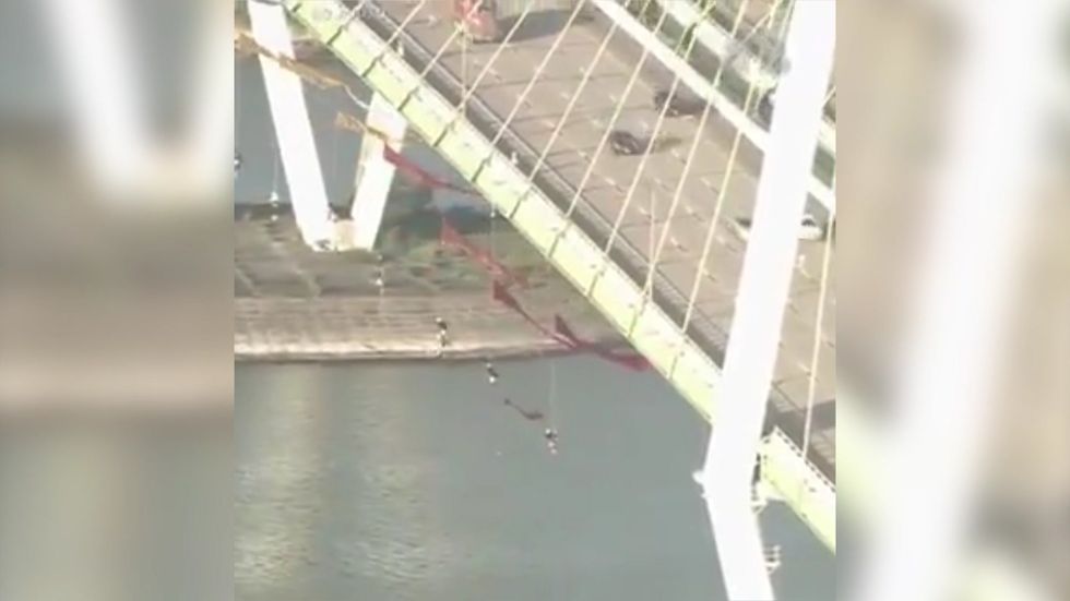 Democratic debate: Greenpeace activists suspend themselves from Houston bridge over climate change