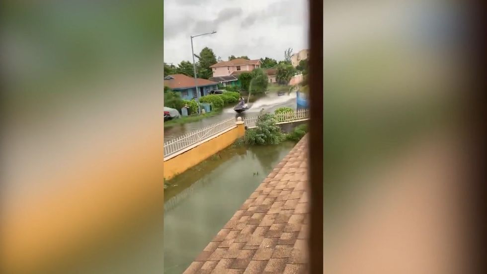 Man drives jet ski in flooded Bahaman street