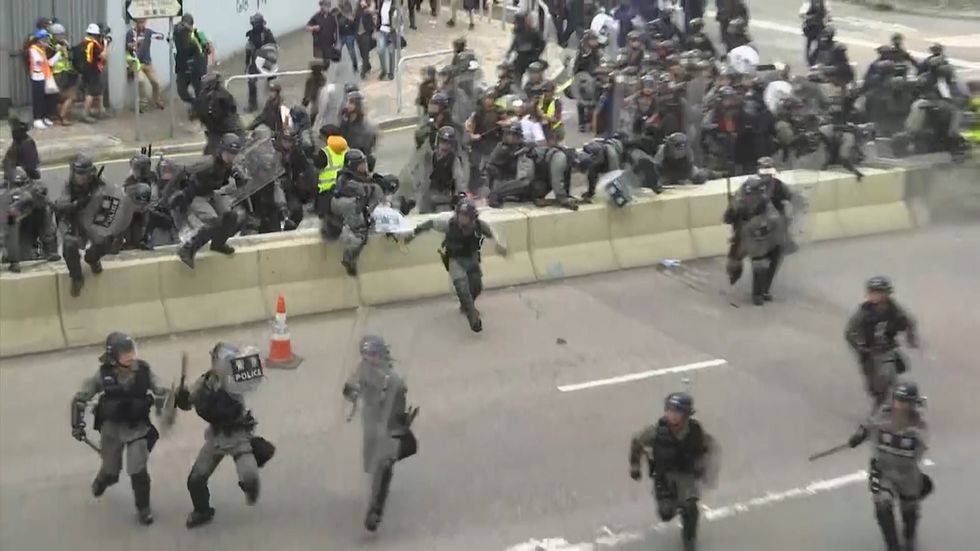 Police and protesters clash in Hong Kong as tear gas and bricks are thrown