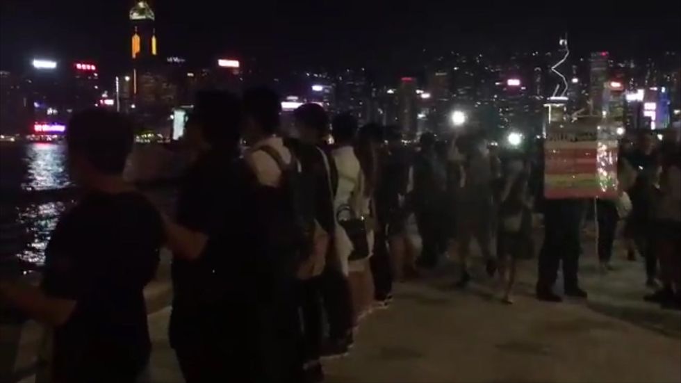 Hong Kong protesters form human chain and sing ‘Do you hear the people sing’ at Tsim Sha Tsui harbour