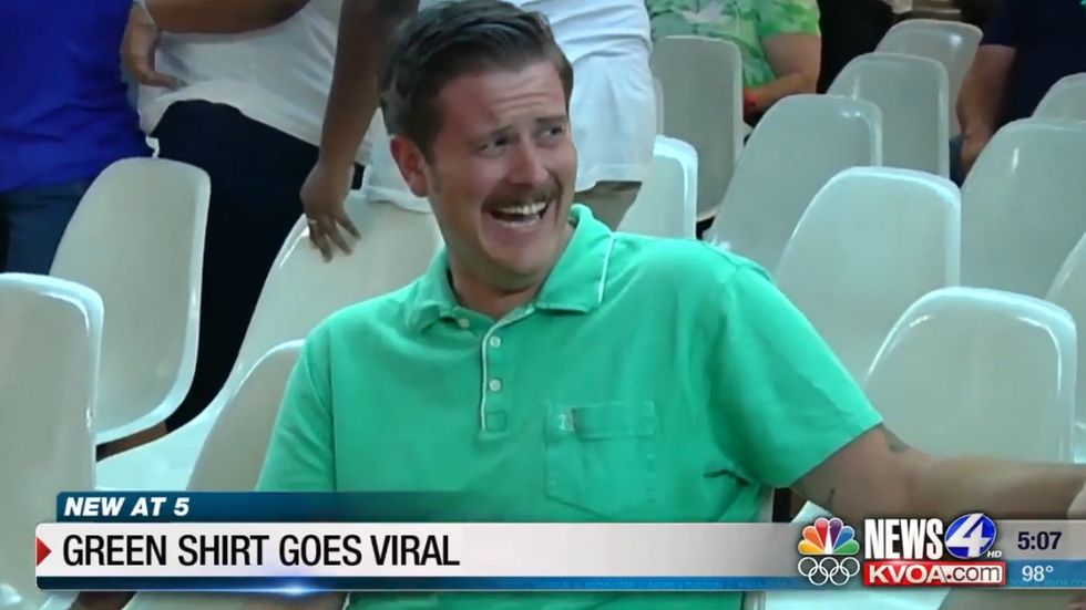 Man laughs at far-right protesters during a city council meeting