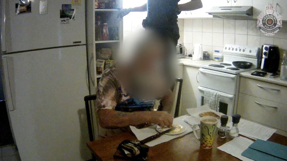 Suspected drug dealer calmly finishes breakfast as police search his home