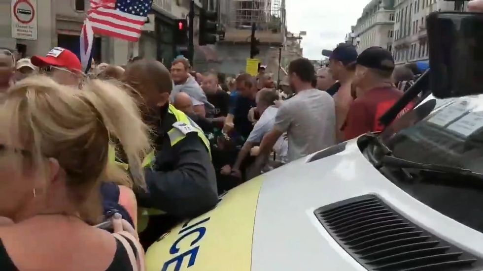 Tommy Robinson supporters attack police officer