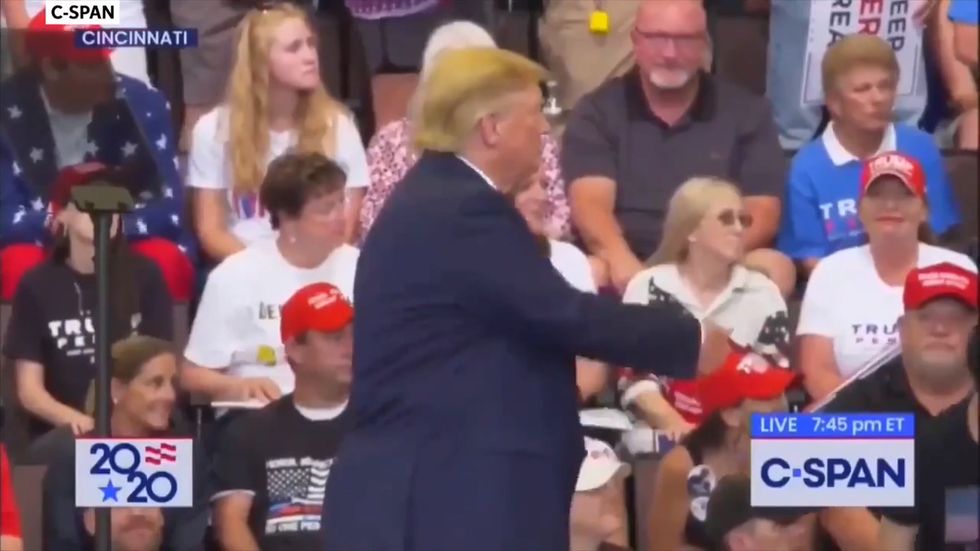 Trump appears to make obscene gesture at rally as protesters kicked out