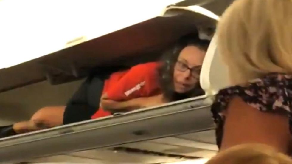 Flight attendant found hiding in overhead luggage bin