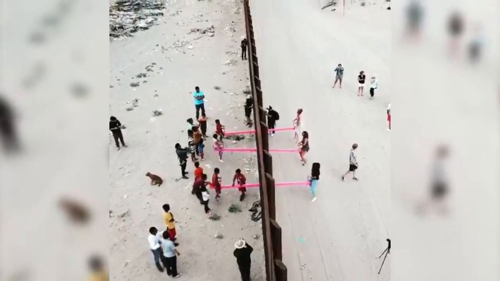 Seesaws installed at US border wall so American and Mexican children can play together