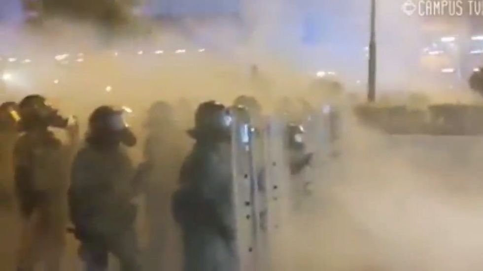 Hong Kong police fire tear gas at protesters only for wind to blow it back at them