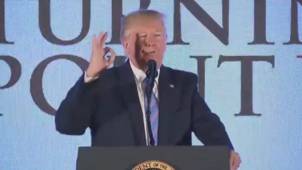 Donald Trump makes hand signal while talking about AOC